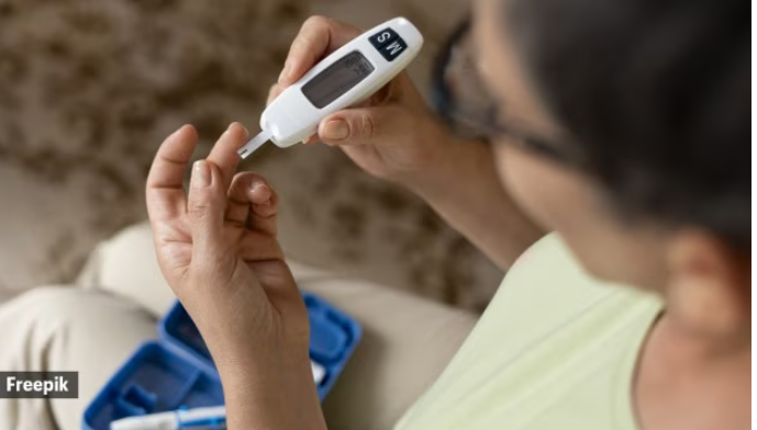Person checking blood sugar levels on a glucometer at home